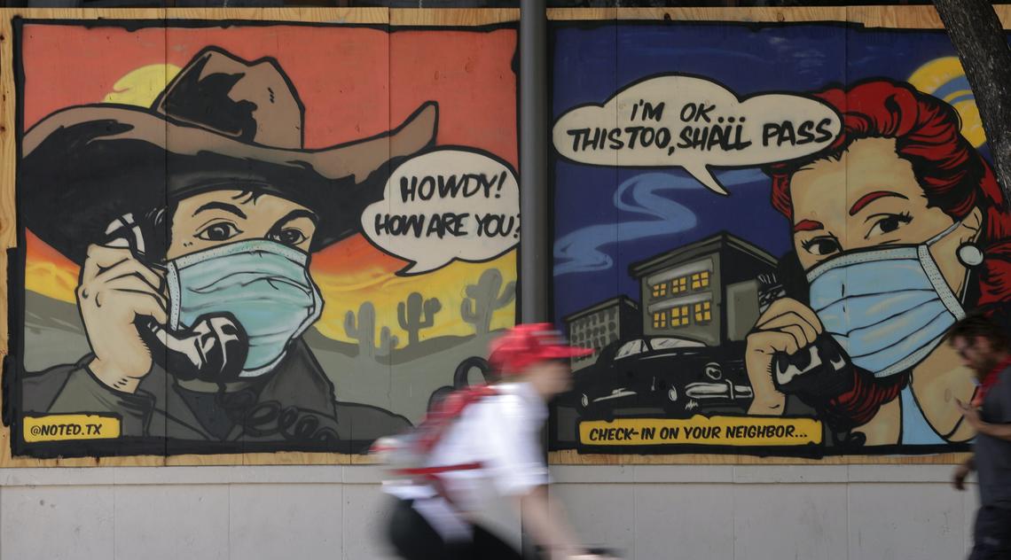 A mural painted on a boarded up business in Austin, Tex., reminds people to check on a neighbour during COVID-19 restrictions, April 27, 2020.