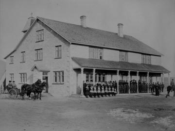 Students, nuns and priests posing in front of St. Joseph's Indian Industrial School, High River, Alberta, 1896.  