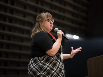 Marissa stands on stage pitching