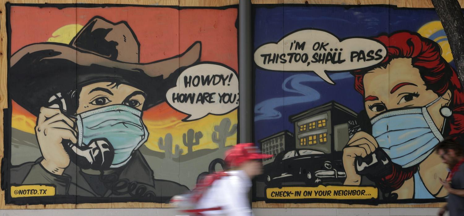 A mural painted on a boarded up business in Austin, Tex., reminds people to check on a neighbour during COVID-19 restrictions, April 27, 2020.
