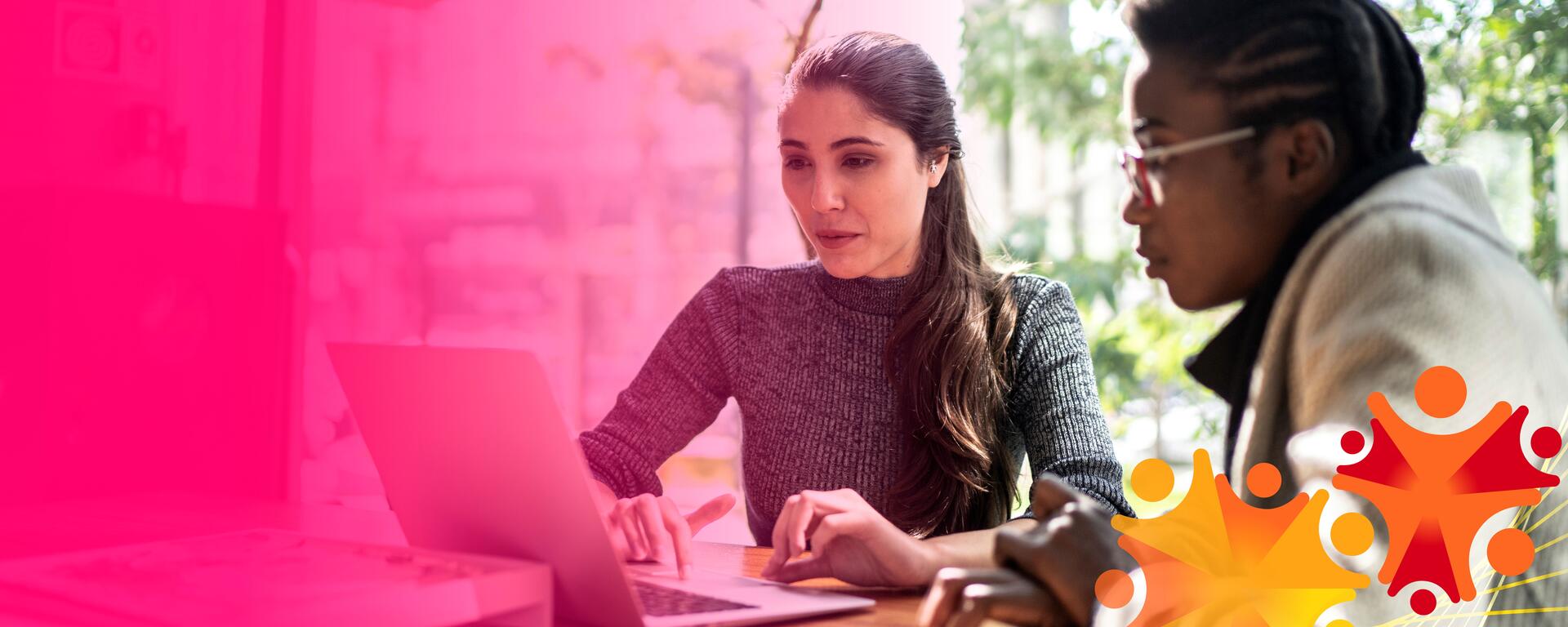 Two people working together on a laptop