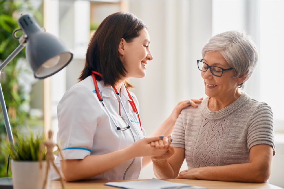 healthcare provider assisting an older woman