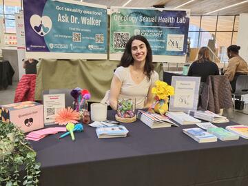 Woman at booth at the Calgary Women's Health Symposium 2025
