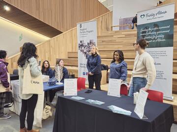 Event attendees at booth at the Calgary Women's Health Symposium 2025