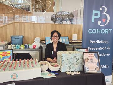 Woman at booth at the Calgary Women's Health Symposium 2025