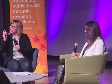 Women talking on stage