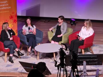 panel of four women on stage talking