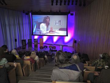 audience watching a screening of film titled Below the Belt