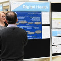 Students look at a poster presentation for eHealth